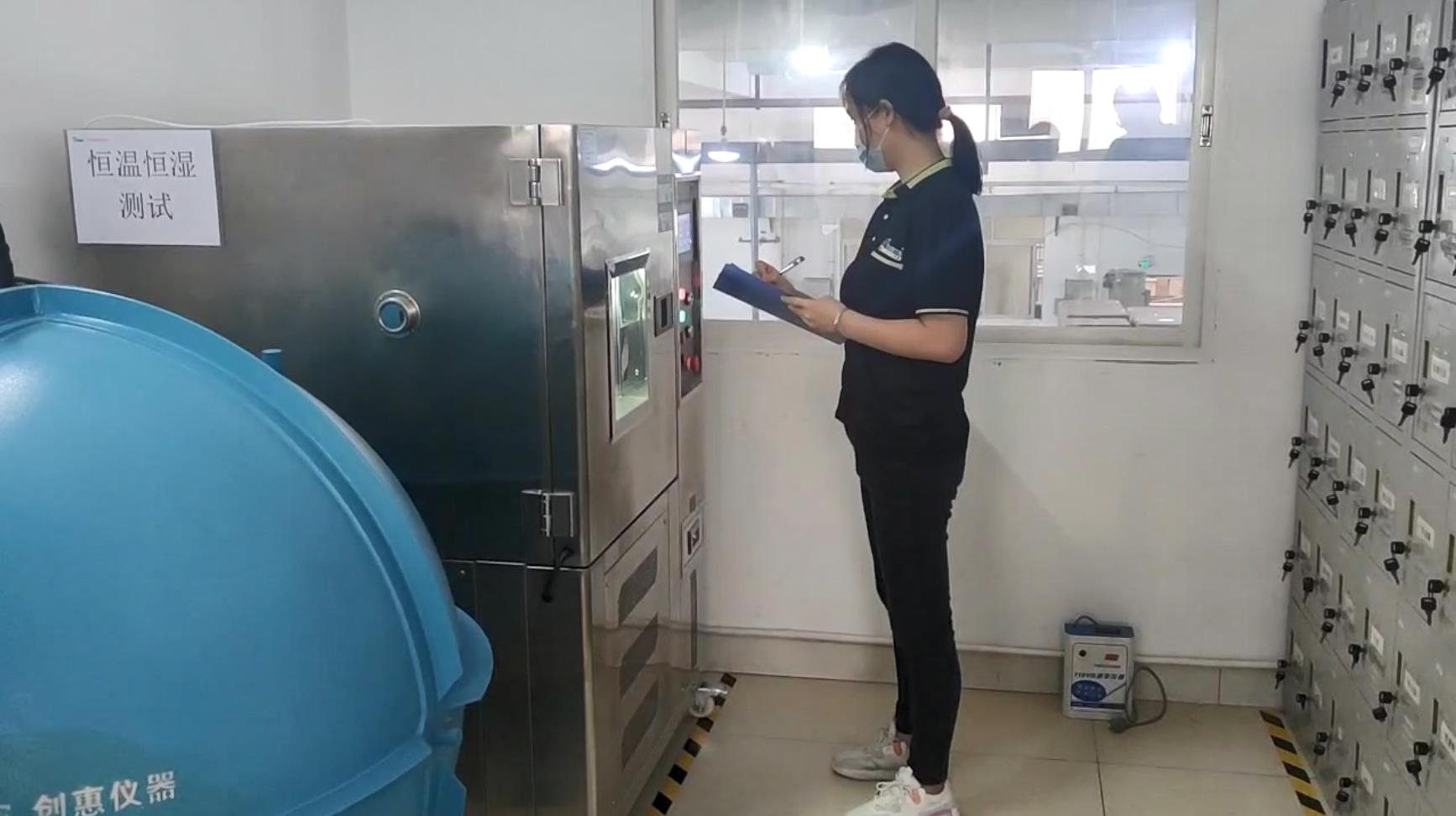 Hengen laboratory staff recording checks beside the test equipment